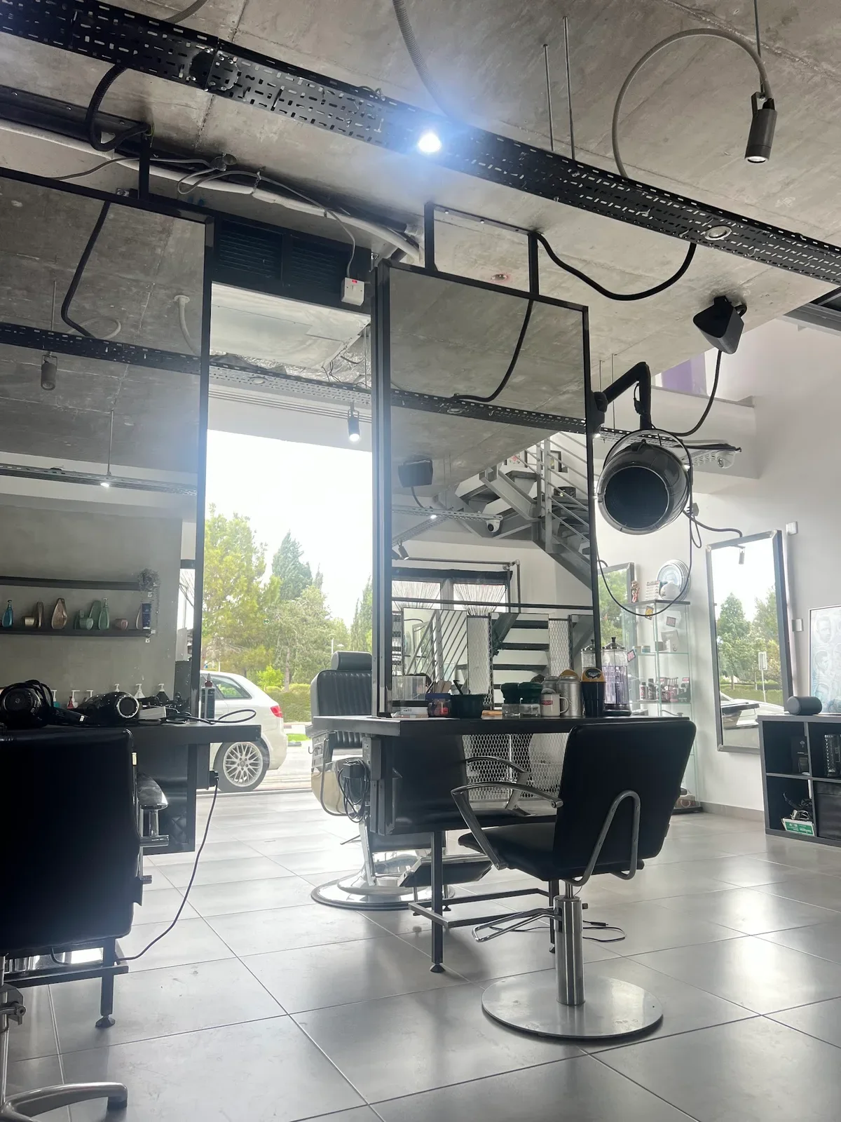 The salon floor with styling chairs and big windows